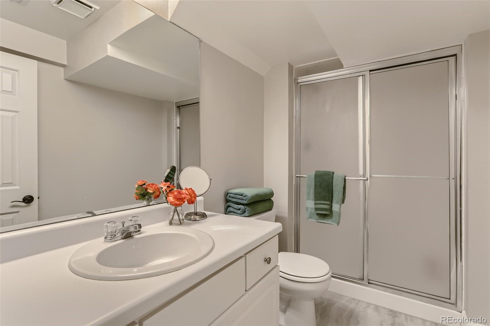 2185 Thistle Ridge Circle Highlands Ranch, CO 80126 - Photo 33 of 37 a bathroom with a sink toilet and shower