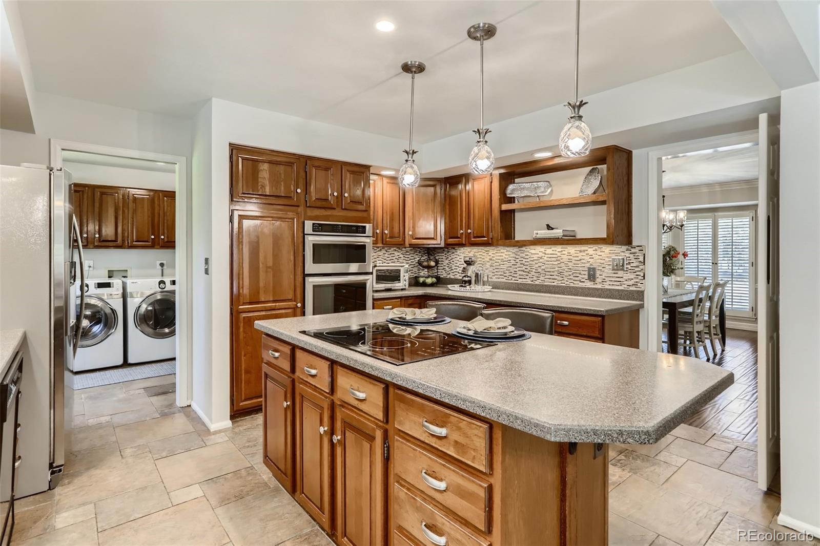 2185 Thistle Ridge Circle Highlands Ranch, CO 80126 - Photo 10 of 37 a kitchen with stainless steel appliances granite countertop a sink refrigerator and cabinets