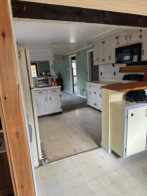 106 Shore Road Becket, MA 01223 - Photo 11 of 29 a kitchen with stainless steel appliances a refrigerator sink and microwave