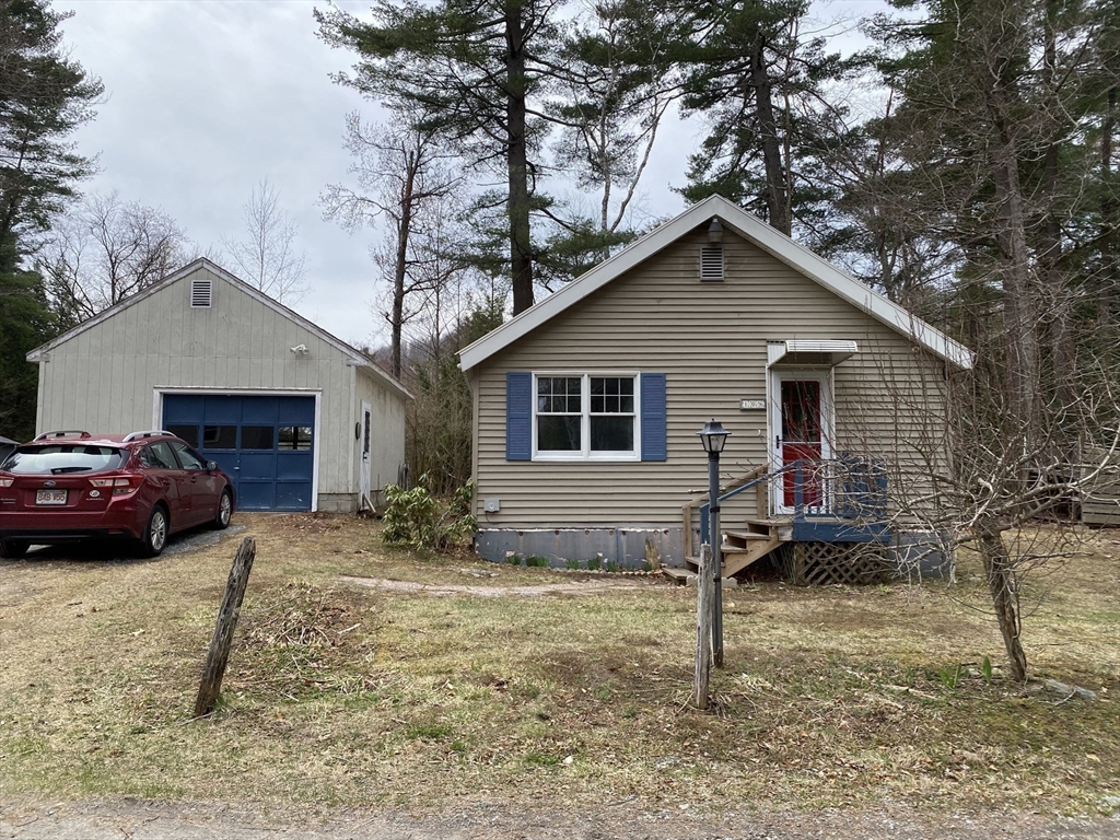 106 Shore Road Becket, MA 01223 - Photo 23 of 29 a view of a house with a yard and garage