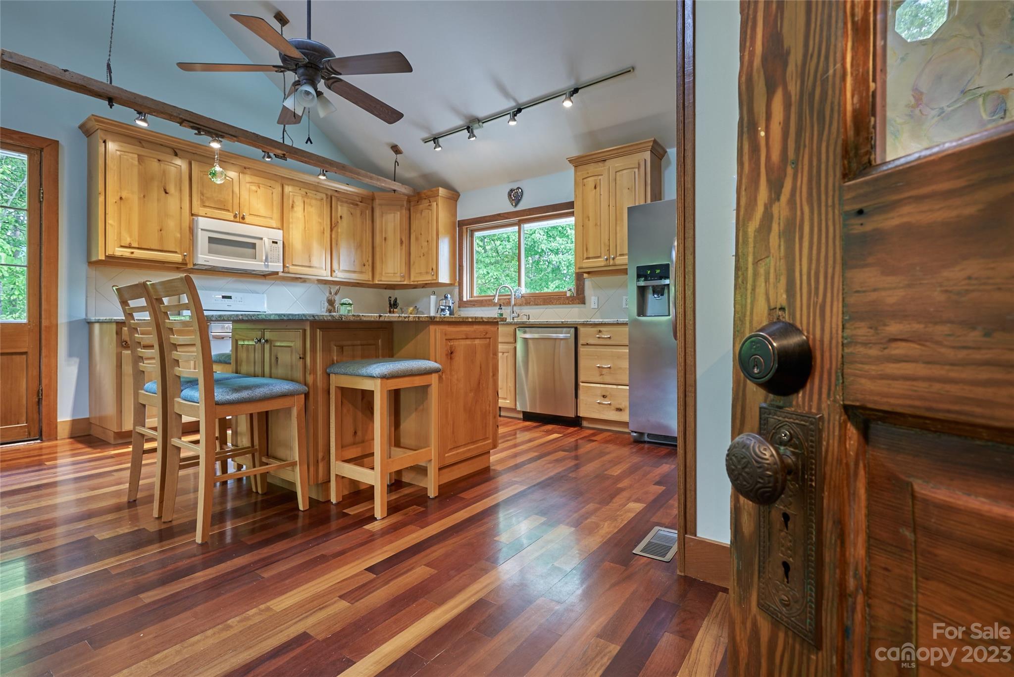 204 Hooker Road Tryon, NC 28782 - Photo 14 of 34 a kitchen with stainless steel appliances granite countertop a refrigerator a stove and wooden floors