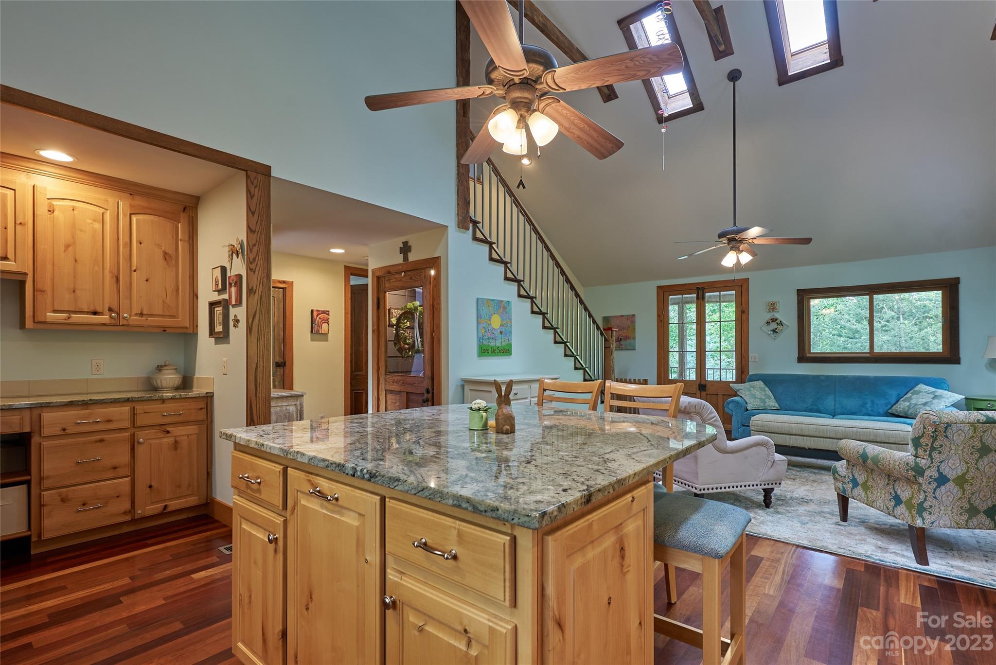 204 Hooker Road Tryon, NC 28782 - Photo 17 of 34 a kitchen with kitchen island granite countertop a stove a sink a dining table and chairs with wooden floor