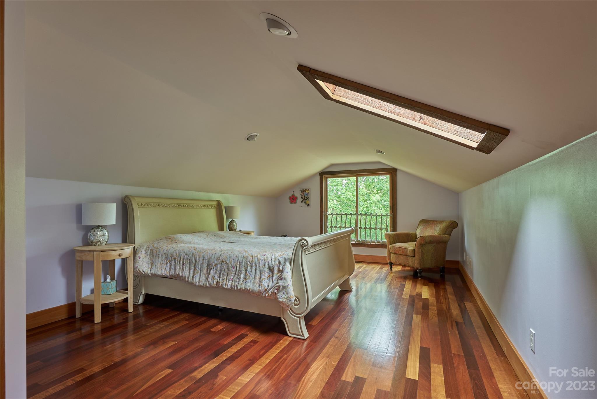 204 Hooker Road Tryon, NC 28782 - Photo 20 of 34 a living room with a bed furniture and a wooden floor