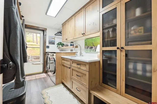a kitchen with stainless steel appliances a stove and white cabinets