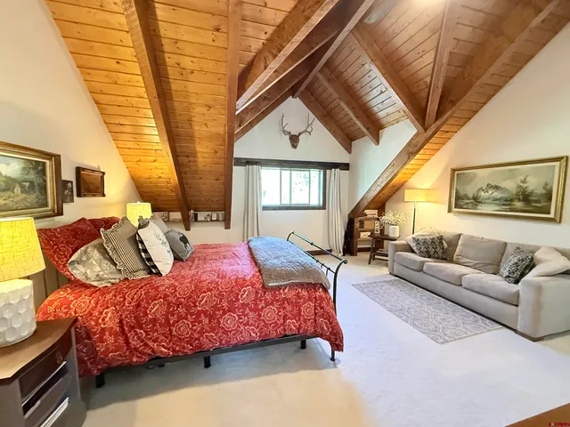 a bedroom with furniture and a large window