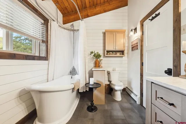 a bathroom with a toilet a sink and a bathtub