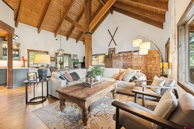 a living room with furniture and a floor to ceiling window