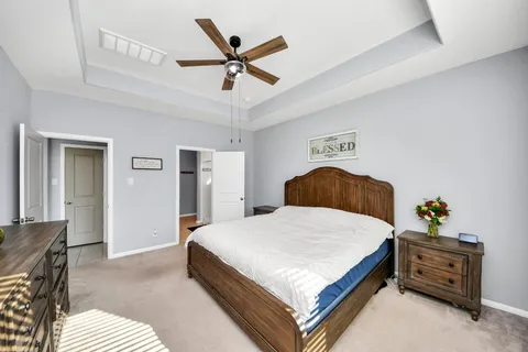 a bedroom with a bed and ceiling fan