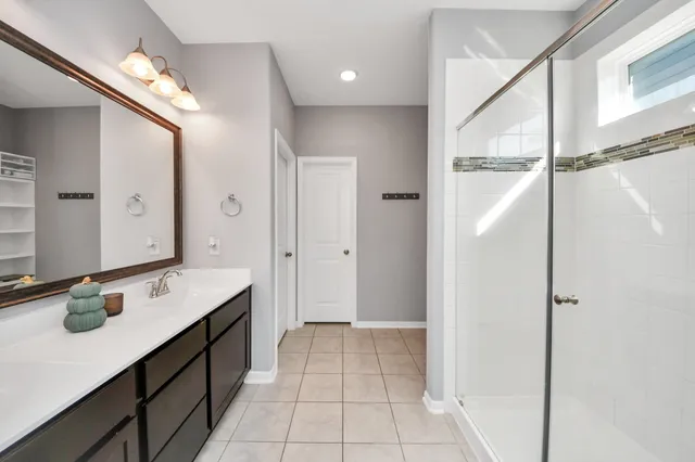 a bathroom with a shower and a glass door