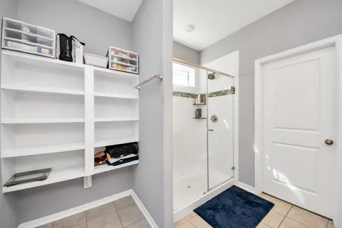 a view of walk in closet with empty racks