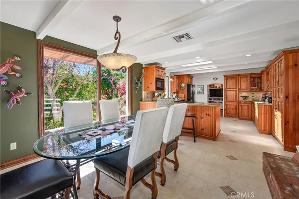 a view of a chair and table in backyard of the house