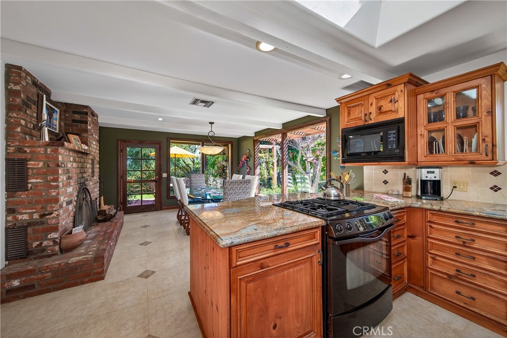 707 Wabash Avenue Redlands, CA 92374 - Photo 16 of 50 a kitchen that has a sink a stove and a wooden cabinets