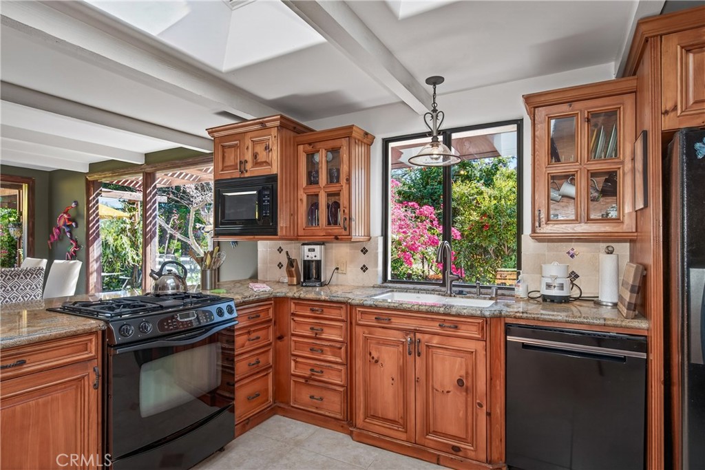 707 Wabash Avenue Redlands, CA 92374 - Photo 17 of 50 a kitchen with stainless steel appliances granite countertop a stove a sink and a microwave
