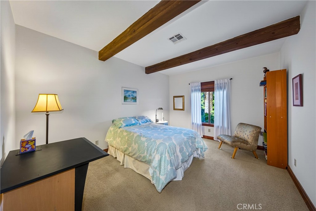 707 Wabash Avenue Redlands, CA 92374 - Photo 24 of 50 a bed room with a bed and a lamp