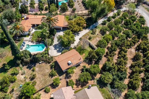 an aerial view of a house with a yard and garden