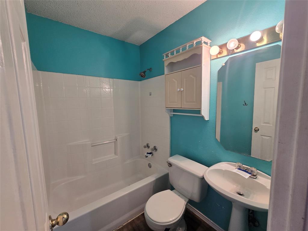 8012 Ashridge Road Fort Worth, TX 76134 - Photo 16 of 18 a bathroom with a sink toilet and shower