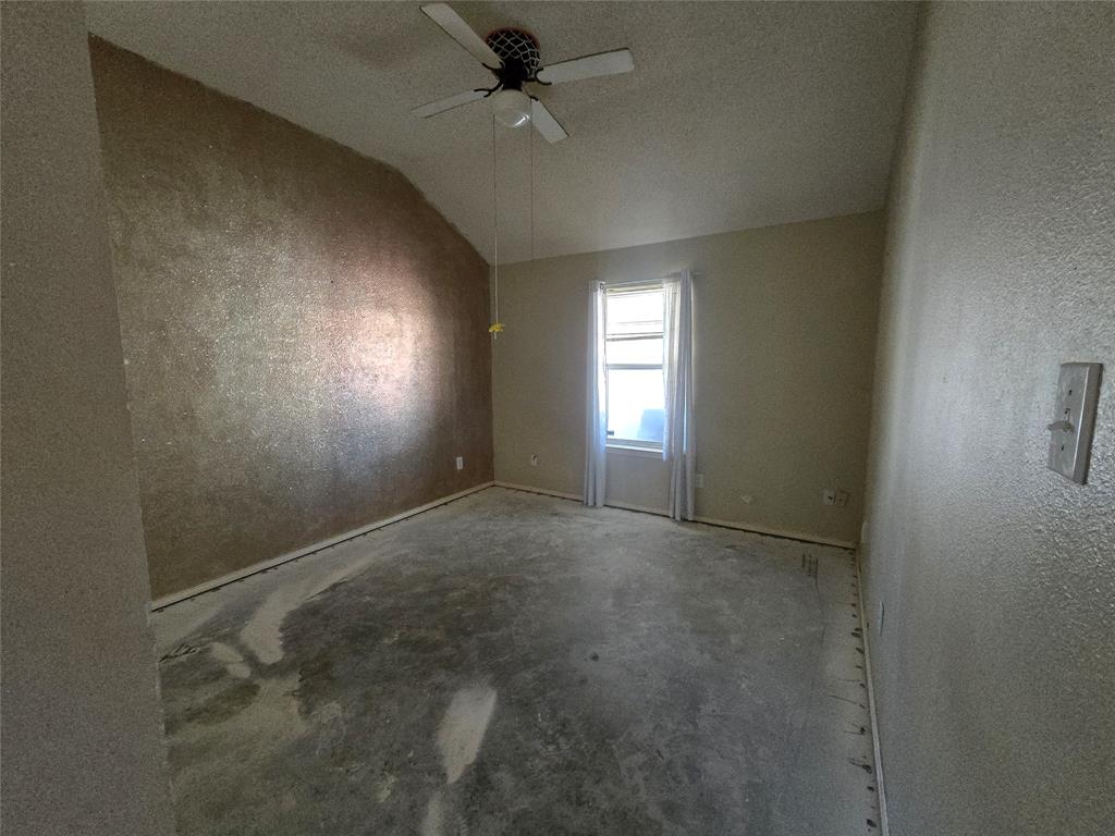 8012 Ashridge Road Fort Worth, TX 76134 - Photo 17 of 18 an empty room with windows and fan