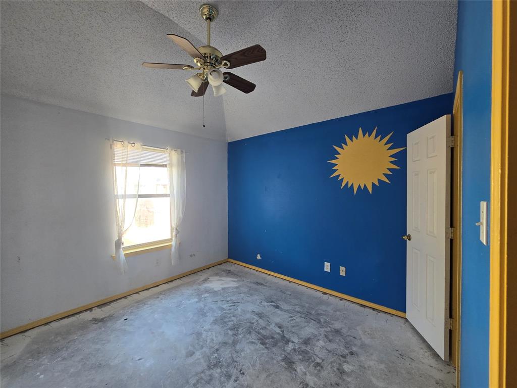 8012 Ashridge Road Fort Worth, TX 76134 - Photo 18 of 18 an empty room with windows and fan