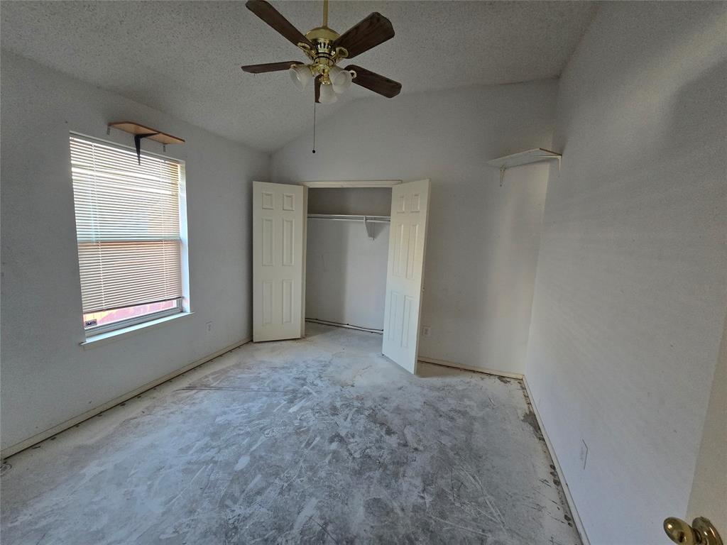 8012 Ashridge Road Fort Worth, TX 76134 - Photo 19 of 20 an empty room with windows and fan