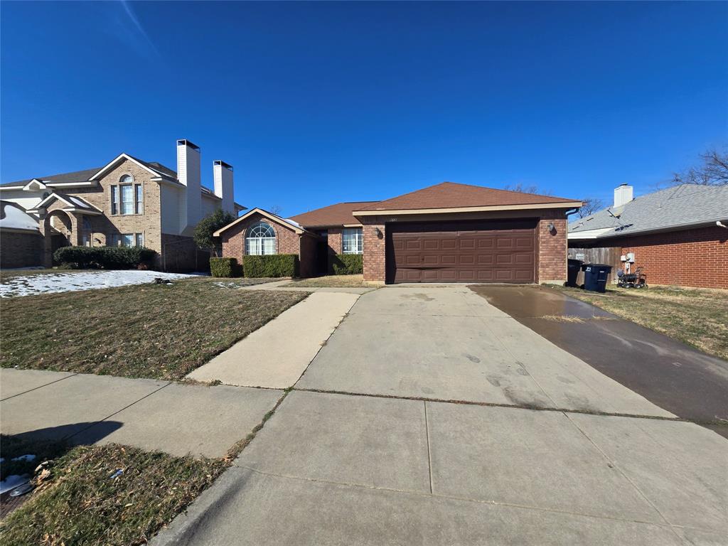 8012 Ashridge Road Fort Worth, TX 76134 - Photo 2 of 18 a front view of a house with a yard and garage
