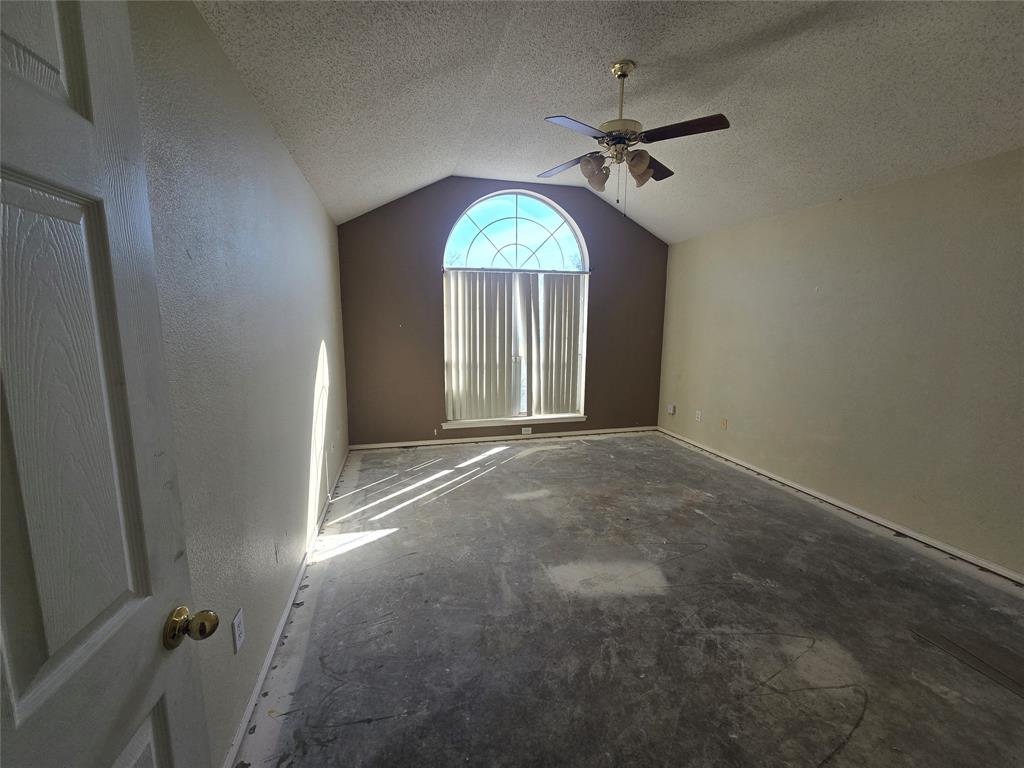 8012 Ashridge Road Fort Worth, TX 76134 - Photo 5 of 18 an empty room with a window and a chandelier