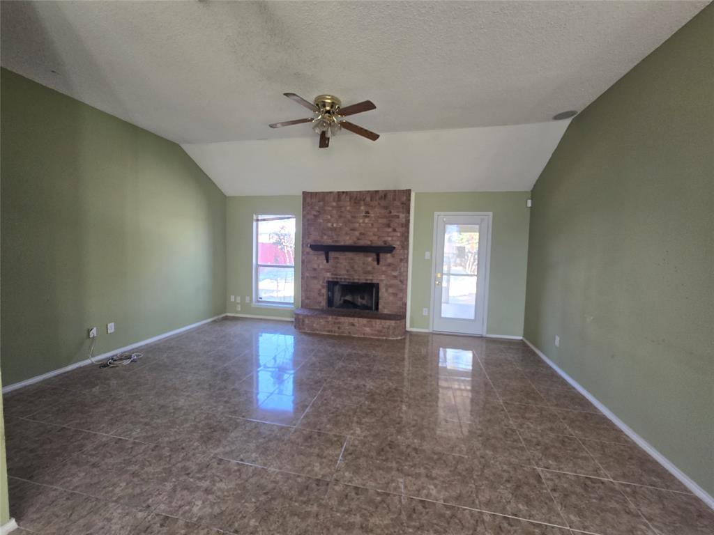 8012 Ashridge Road Fort Worth, TX 76134 - Photo 8 of 18 a view of empty room with fireplace and window