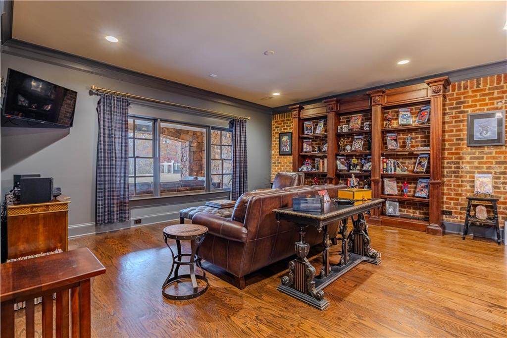 525 North River Road Northeast Rome, GA 30161 - Photo 43 of 101 a living room with furniture a bookshelf and a flat screen tv