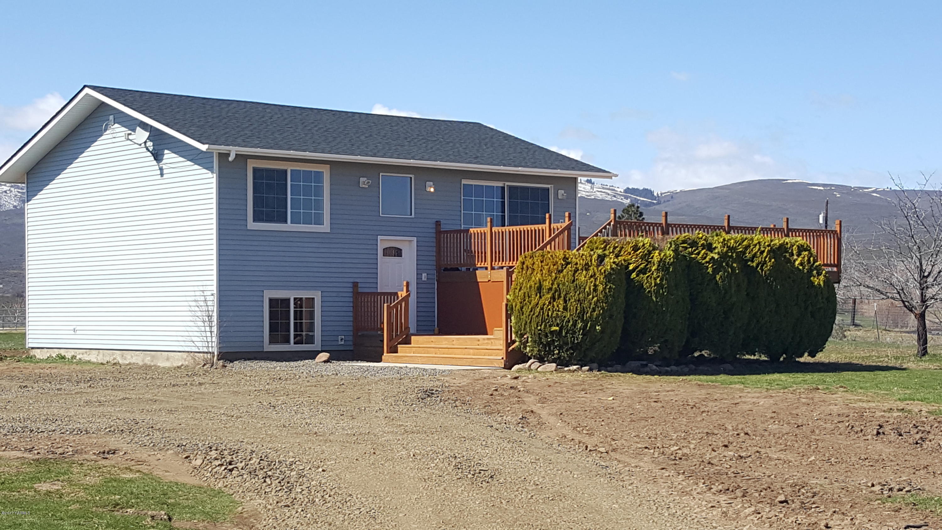 135 Slavin Heights Road Yakima, WA 98903 - Photo 1 of 25 a view of a house with a yard