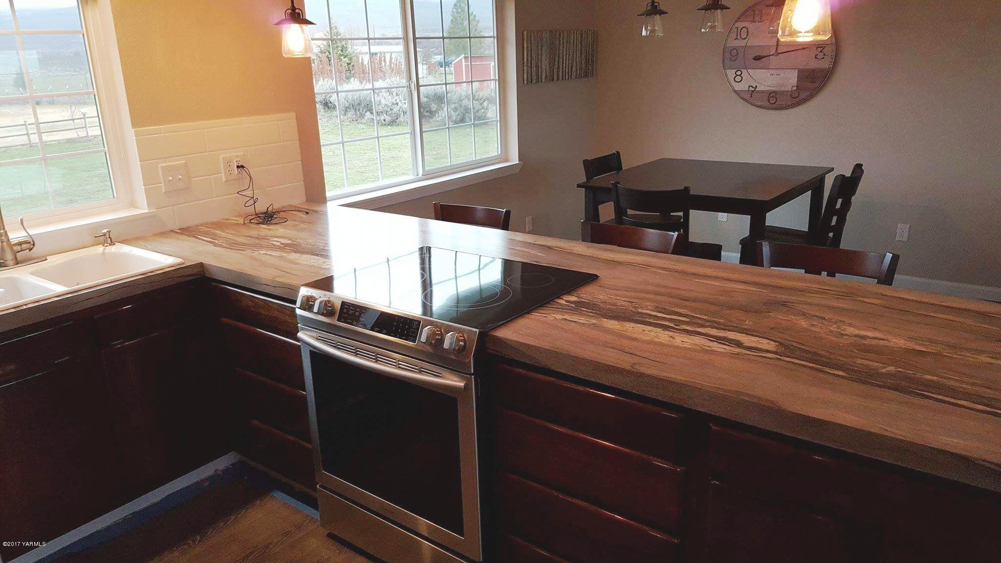 135 Slavin Heights Road Yakima, WA 98903 - Photo 12 of 25 a kitchen with a table chairs and a window
