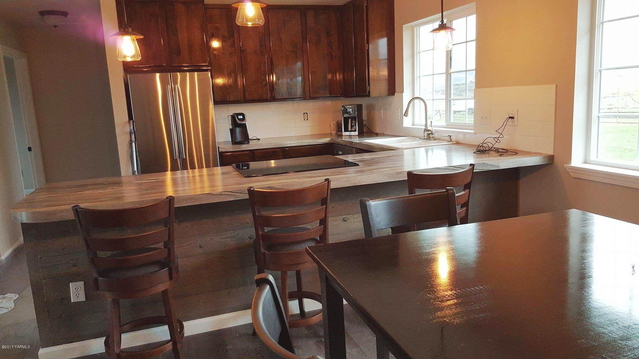 135 Slavin Heights Road Yakima, WA 98903 - Photo 15 of 25 a kitchen with stainless steel appliances granite countertop a sink table and chairs