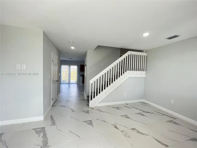 wooden floor in a hall with a window