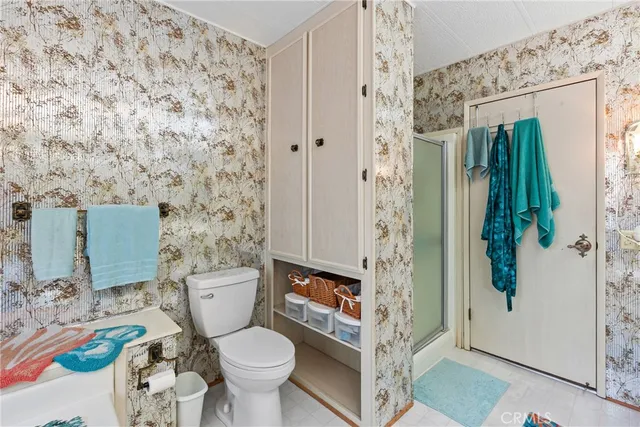 a bathroom with a toilet and a shower