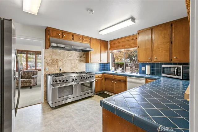 a living room with furniture pool table and windows