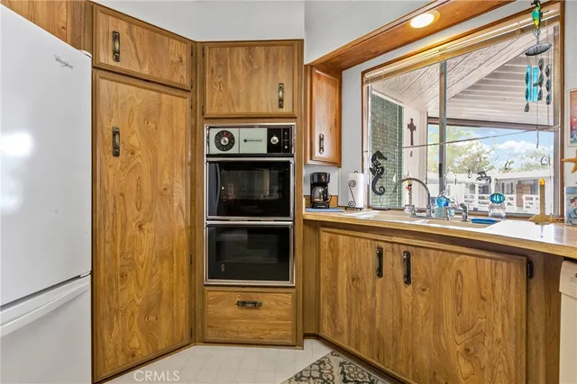 a kitchen with a refrigerator and a sink