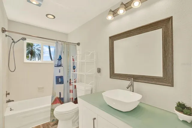 a bathroom with a sink toilet and shower