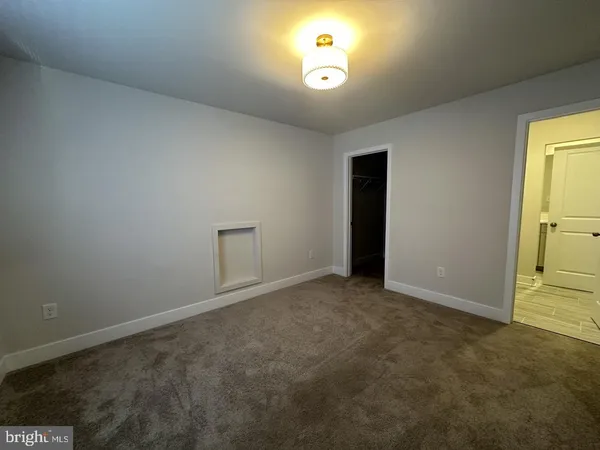 an empty room with a view of a bathroom