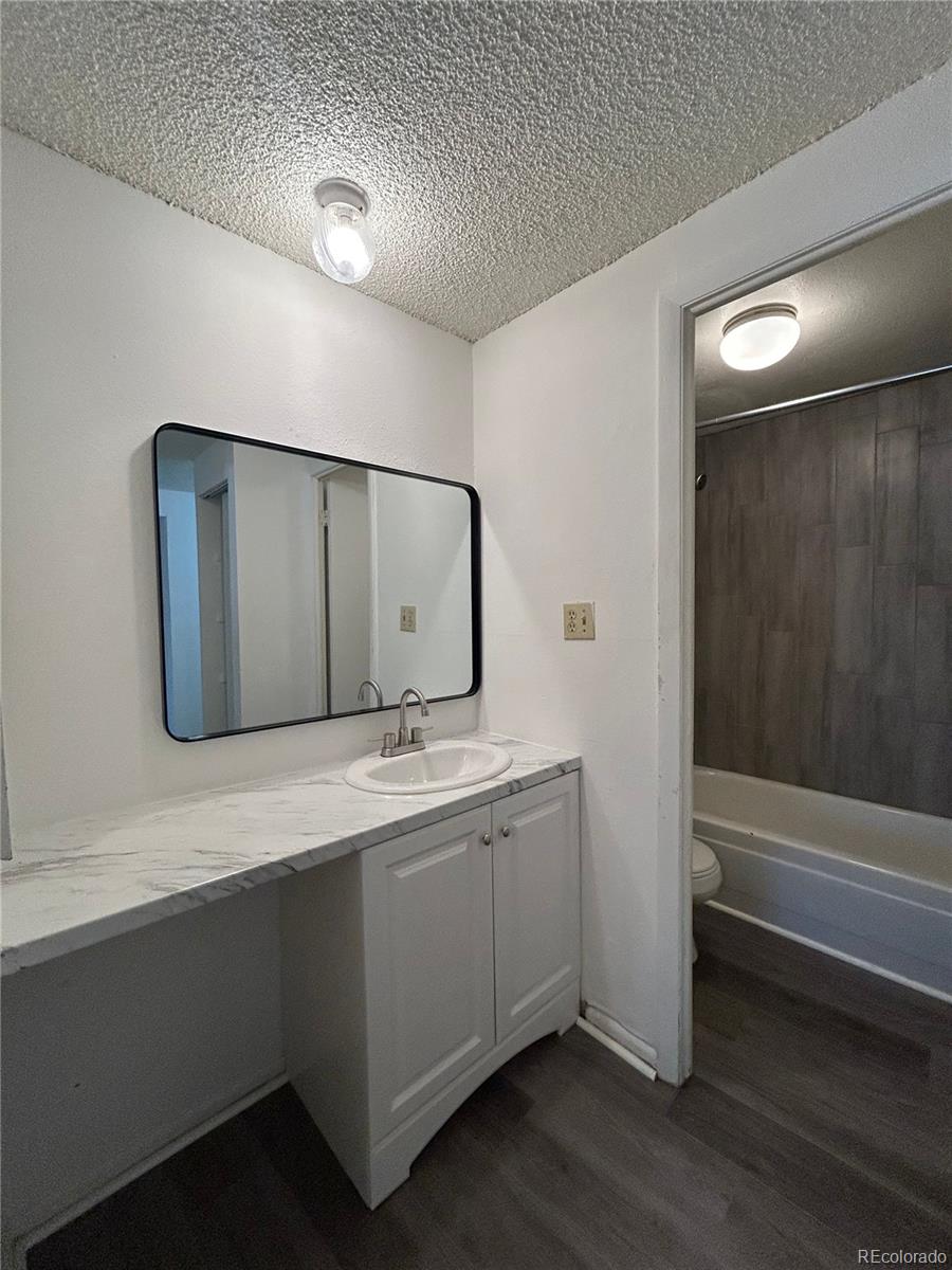 1306 South Parker Road, Unit 167 Denver, CO 80231 - Photo 8 of 14 a bathroom with a double vanity sink and mirror