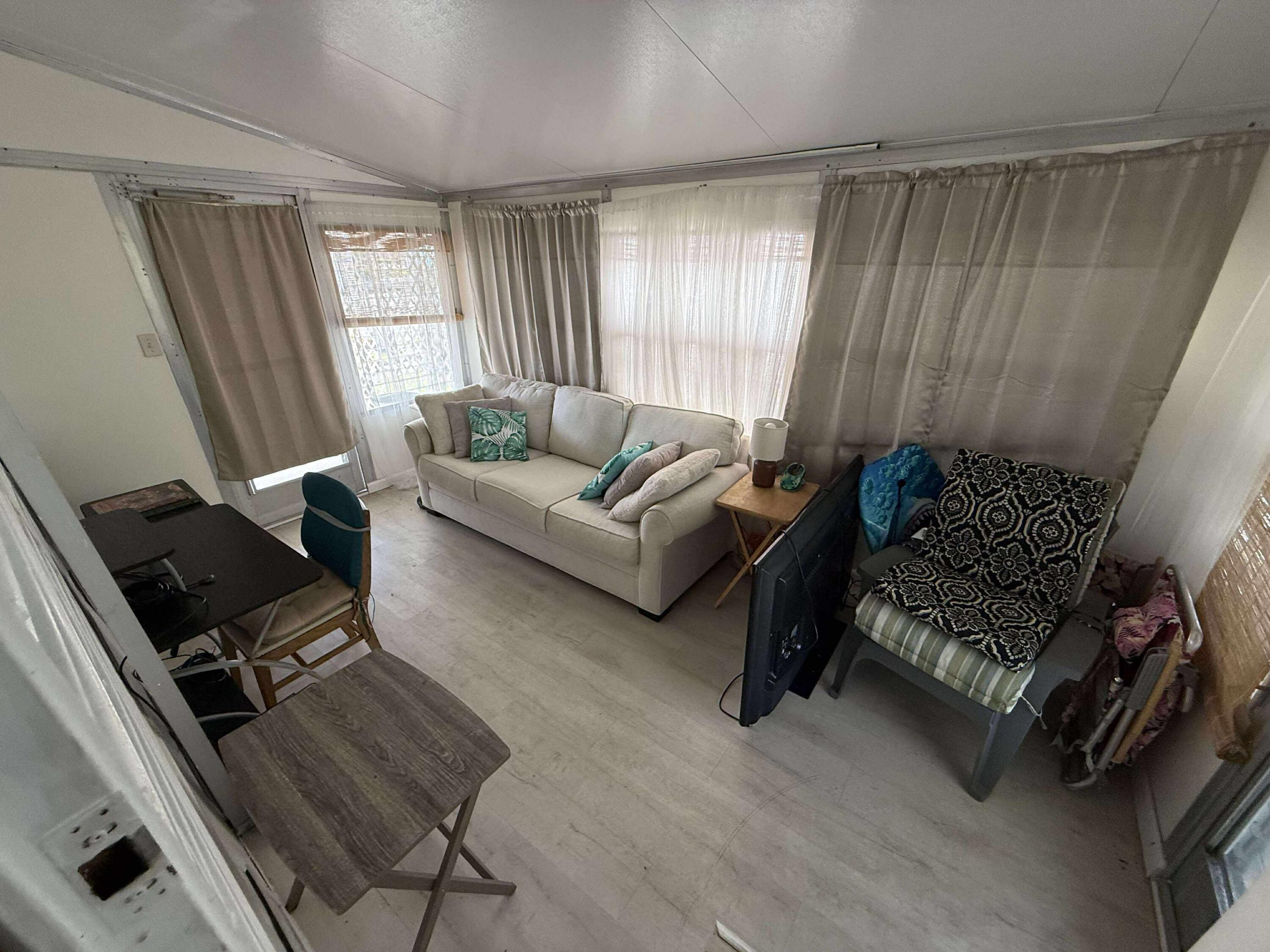 21 Ruthmary Avenue, Unit G Briny Breezes, FL 33435 - Photo 12 of 15 a living room with furniture rug and window