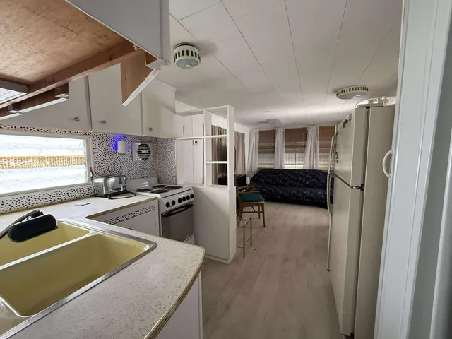 a kitchen with stainless steel appliances a refrigerator and a stove top oven