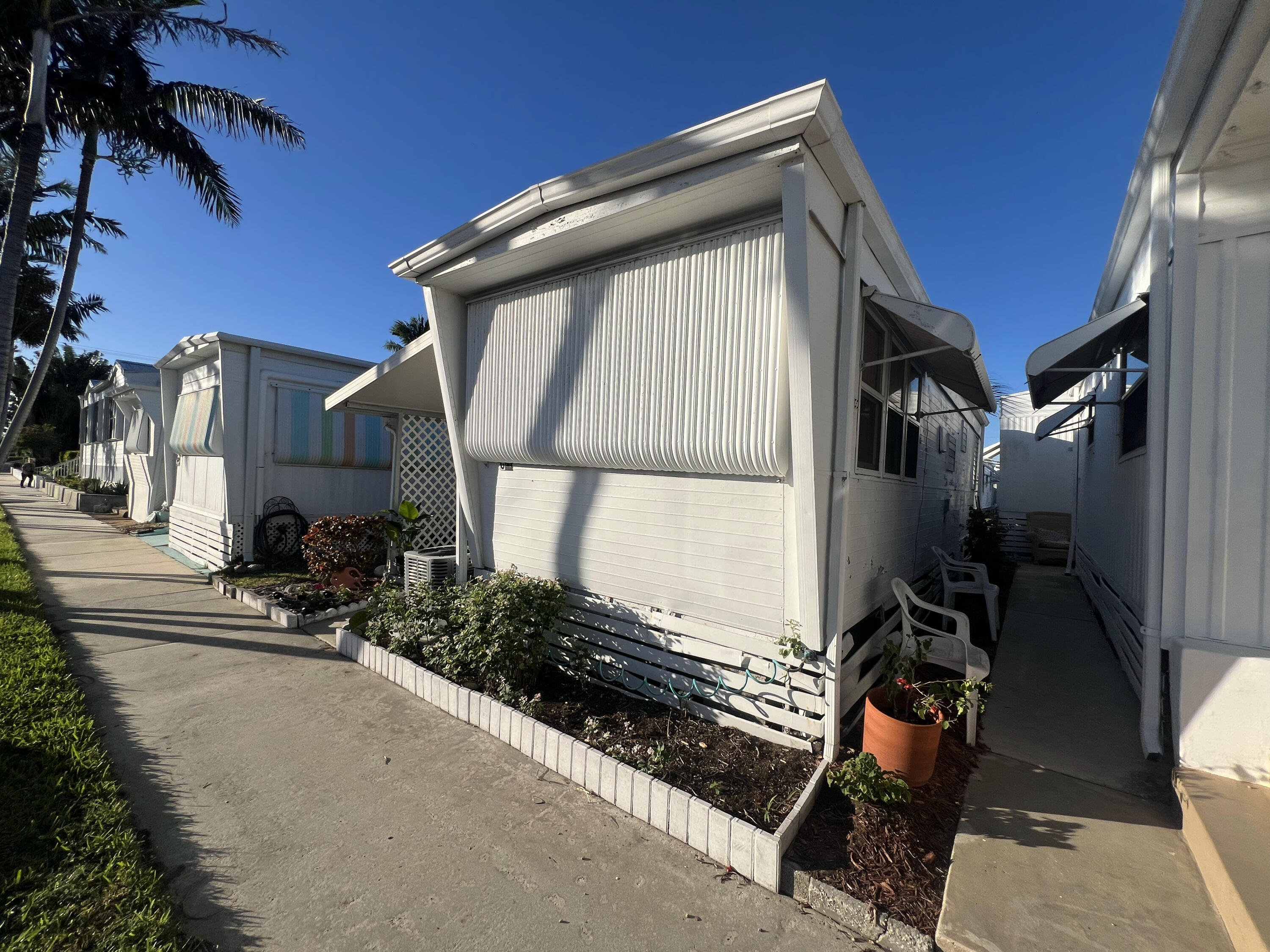 21 Ruthmary Avenue, Unit G Briny Breezes, FL 33435 - Photo 10 of 15 a view of a house with a car parked car