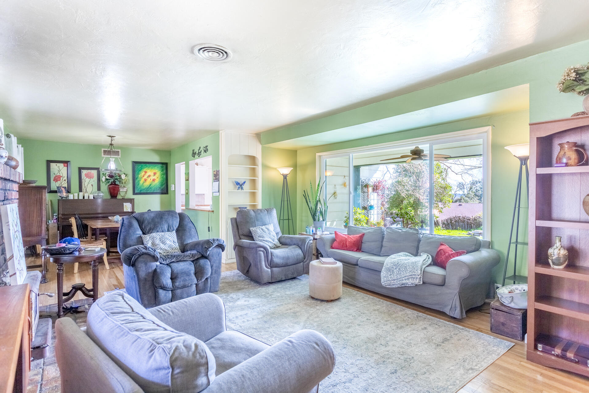 1715 Barbara Road Redding, CA 96003 - Photo 14 of 32 a living room with furniture and a floor to ceiling window