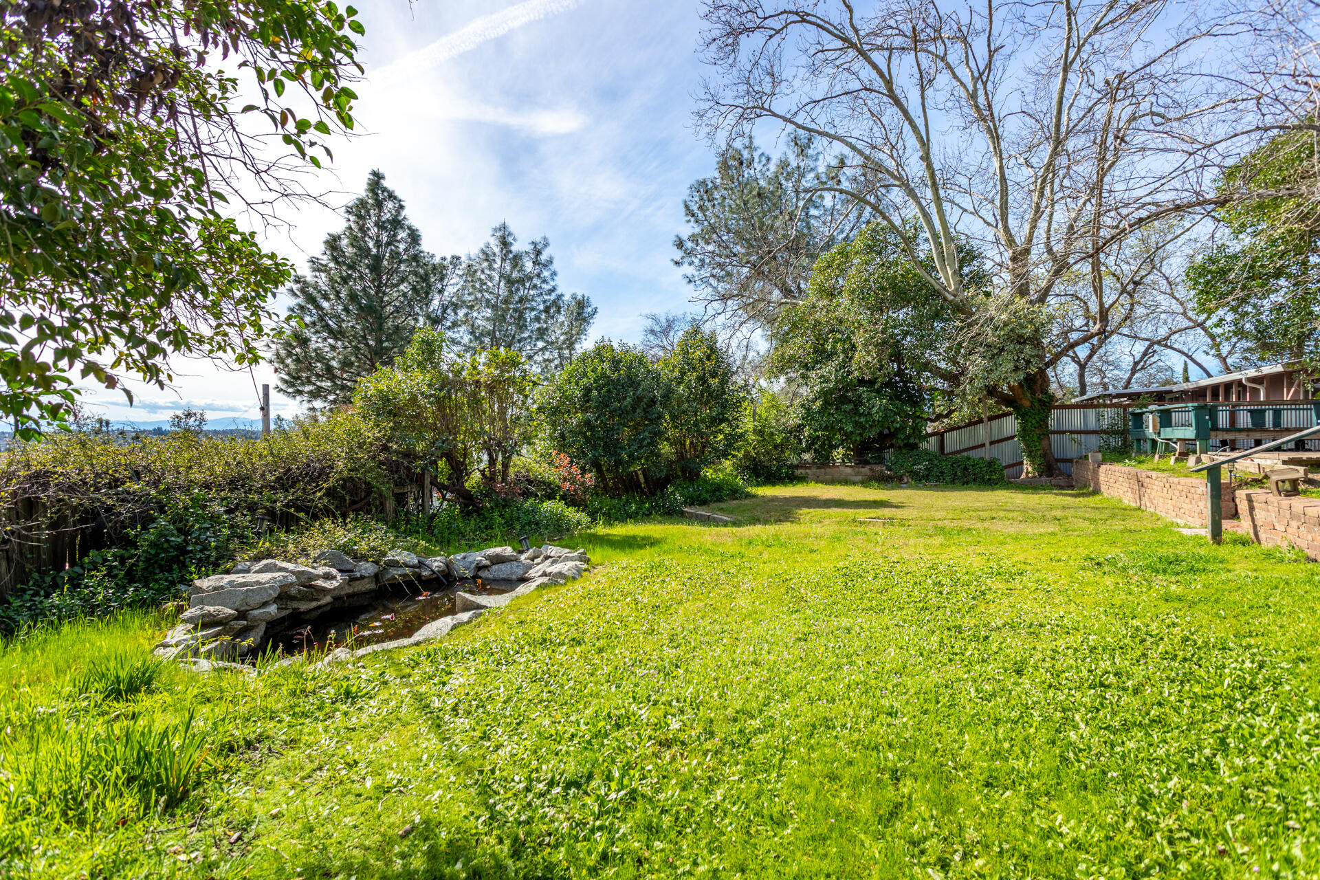 1715 Barbara Road Redding, CA 96003 - Photo 26 of 32 a view of yard with swimming pool and green space