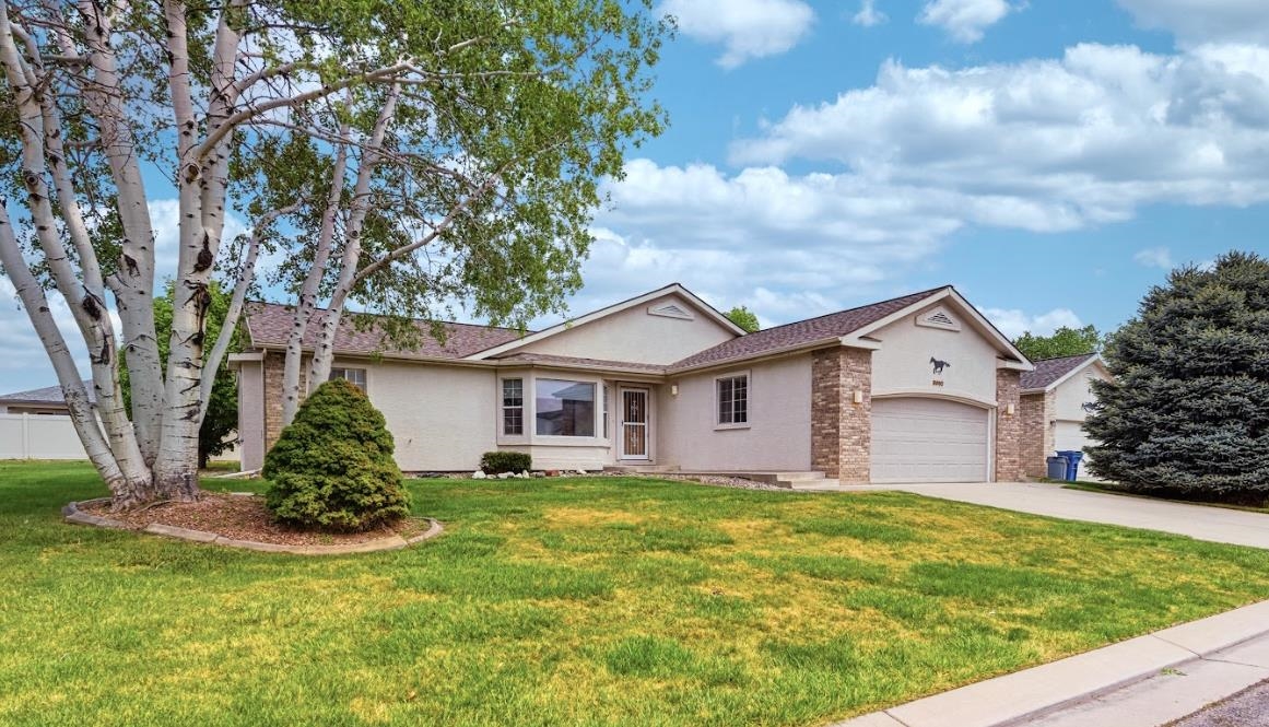3082 Shadowbrook Court Grand Junction, CO 81504 - Photo 27 of 28 a view of a house with a yard and large tree