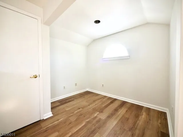 an empty room with wooden floor