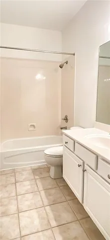 a bathroom with a granite countertop toilet a sink and bathtub