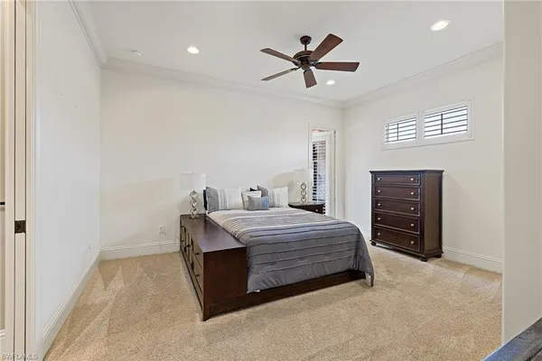 a bedroom with a bed dresser and a window