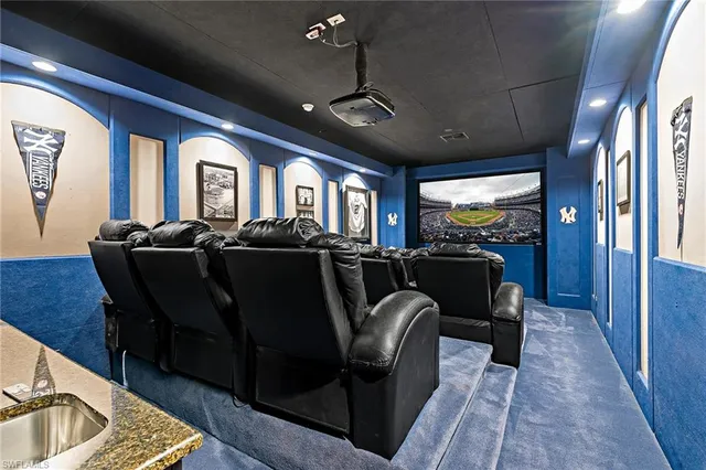 a living room with furniture a chandelier and a dining table with wooden floor