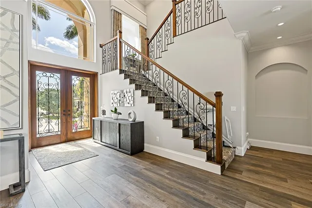 a view of entryway and hall with wooden floor