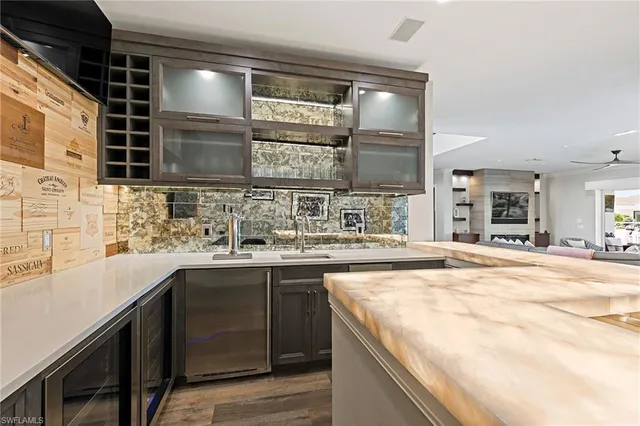 a kitchen with stainless steel appliances granite countertop a sink and stove