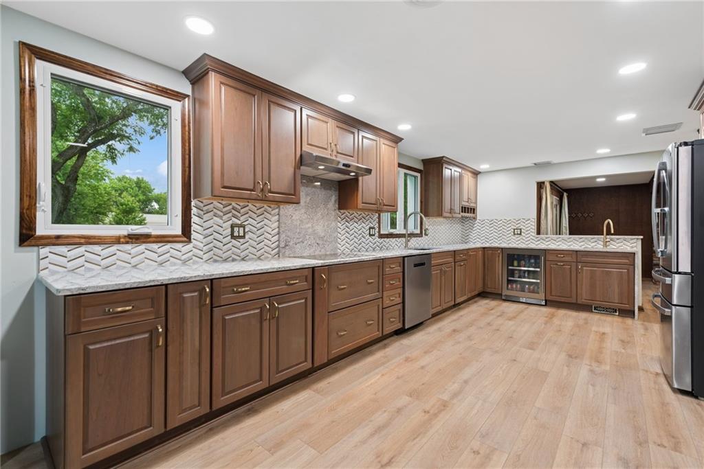 22 Buzzardtown Road Irwin, PA 15642 - Photo 7 of 44 a large kitchen with a large window and stainless steel appliances